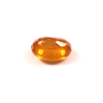 Faceted yellow gemstone on a white background