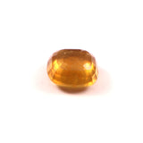 Faceted yellow gemstone on a white background