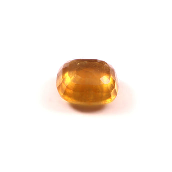 Faceted yellow gemstone on a white background