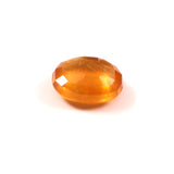 Faceted orange gemstone on a white background