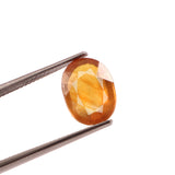 yellow sapphire (pukhraj) 5.10 carat stone on white background 