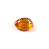 yellow sapphire (pukhraj) 7.38 carat stone on white background 