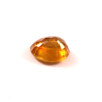 yellow sapphire (pukhraj) 7.38 carat stone on white background 