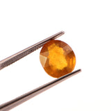 yellow sapphire (pukhraj) 7.38 carat stone on white background 