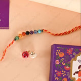 Colorful beaded bracelet with a purple box featuring floral designs on a beige background