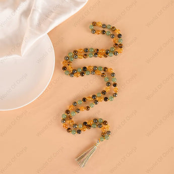 Beaded necklace with a tassel on a beige background