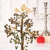 Decorative tree with green and gold leaves on a white background