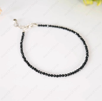 Black beaded necklace on a white background