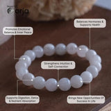 White beaded bracelet with health benefits text on a wooden surface, featuring the brand 'orja'.