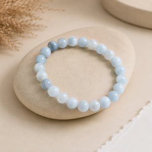 Aquamarine bracelet with soft pale blue translucent beads on a cream river stone with dried pampas grass – World of Oorja