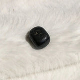 Tumble Black tourmaline on a white fur surface