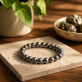 Natural Hematite bracelet with polished metallic grey beads on a cream stone – World of Oorja