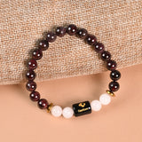 Capricorn Garnet and Milky Quartz zodiac bracelet flat lay