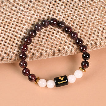 Capricorn Garnet and Milky Quartz zodiac bracelet flat lay