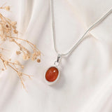 Carnelian pendant in Classic bezel setting — warm orange stone in silver frame