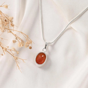 Carnelian pendant in Classic bezel setting — warm orange stone in silver frame