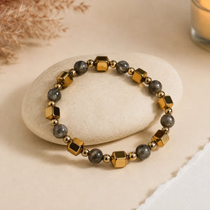 Double Power Money Attraction bracelet with faceted gold cubes and grey pyrite beads on a cream pebble – World of Oorja