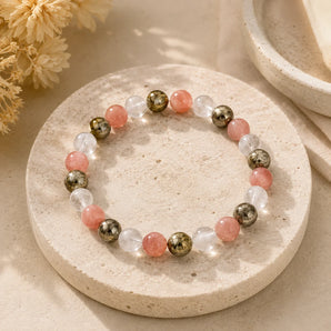 Fame and Recognition bracelet with metallic pyrite, soft pink and clear quartz beads on a travertine stone coaster – World of Oorja