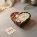 Happy Rakhi vanilla heart bowl candle — carved wooden heart with letter beads, dried rose petals and pearls, tied with jute twine