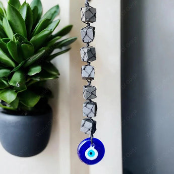 Black Tourmaline cubes with blue Evil Eye charm for protection and energy cleansing