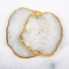 Close-up of a piece of white Agate coasters with gold inlay on a marble surface