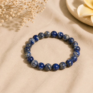 Lapis Lazuli bracelet with deep royal blue beads flecked with gold pyrite and white calcite on beige linen – World of Oorja
