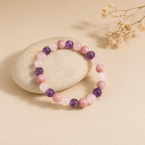 Love and Stress Relief bracelet with rose quartz, amethyst and rhodochrosite beads on a cream pebble – World of Oorja