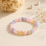 Morganite bracelet with pastel blush pink, lilac and butter yellow beads on a cream backdrop with pearls – World of Oorja