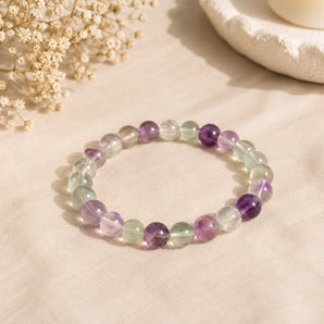 Multi-Fluorite bracelet with translucent mint green, lilac and clear banded beads on pale peach linen – World of Oorja