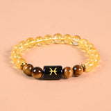 Pisces zodiac bracelet with Pisces glyph engraved onyx bead