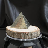 video of pyrite pyramid on a wooden block 