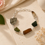 Raw Dhan Yog bracelet with uncut pyrite, tiger eye and quartz slabs on a silver chain, styled on a cream stone – World of Oorja