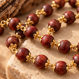 Close-up of Rakt Chandan wood grain and gold-plated flower caps