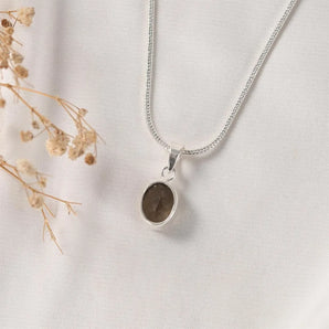 Classic bezel-set Smoky Quartz pendant – oval faceted smoky quartz framed in silver, a grounding crystal necklace by World of Oorja