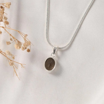 Classic bezel-set Smoky Quartz pendant – oval faceted smoky quartz framed in silver, a grounding crystal necklace by World of Oorja