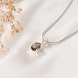 Detail of the Prong style Smoky Quartz pendant showing the faceted stone and open silver setting – World of Oorja