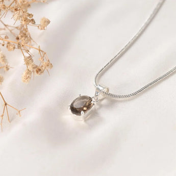 Detail of the Prong style Smoky Quartz pendant showing the faceted stone and open silver setting – World of Oorja