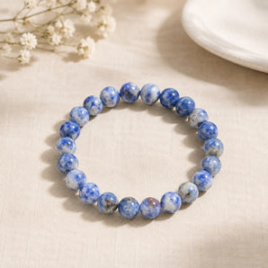 Sodalite bracelet with mottled royal blue and white beads on cream woven linen with dried white baby breath – World of Oorja
