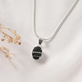 Sulemani Hakik pendant in Prong setting — faceted banded black agate with white bands
