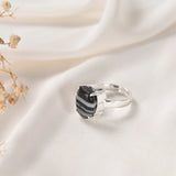 Sulemani Hakik ring in Prong setting — faceted banded black agate held in open claws