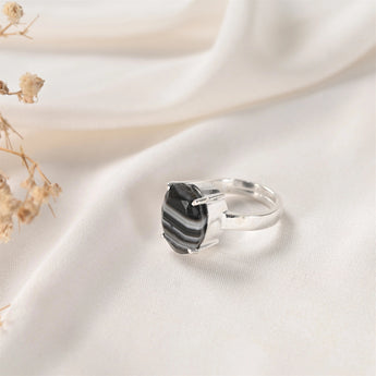 Sulemani Hakik ring in Prong setting — faceted banded black agate held in open claws