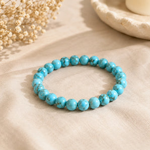 Turquoise Firoza bracelet with sky-blue beads and brown matrix veining on beige linen with dried baby breath – World of Oorja